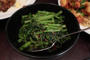 Morning glory vegetables served in a black bowl