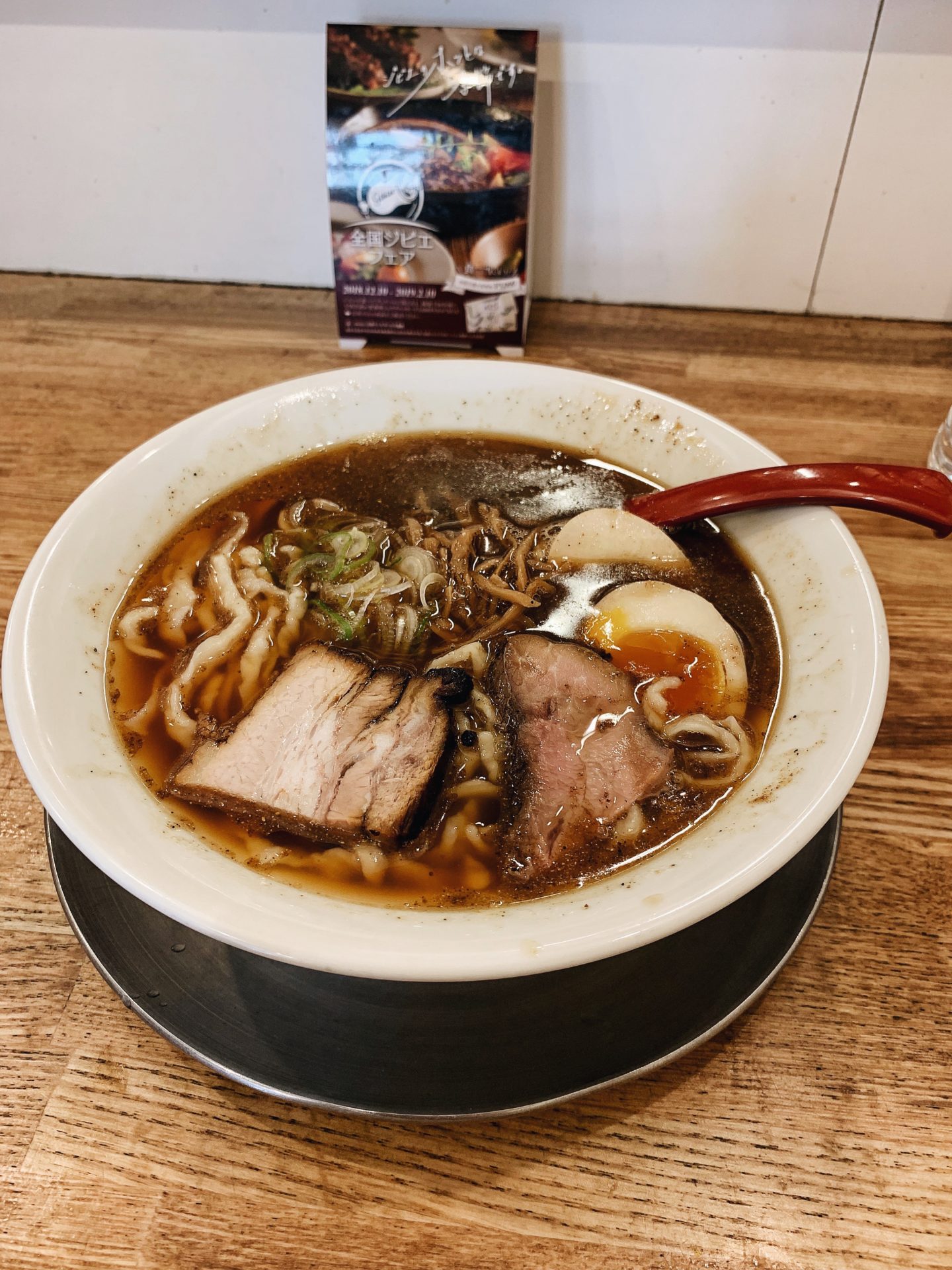 Bowl of ramen with pork slices and boiled egg sliced in half