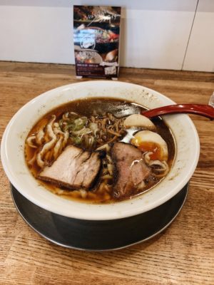 Bowl of ramen with pork slices and boiled egg sliced in half