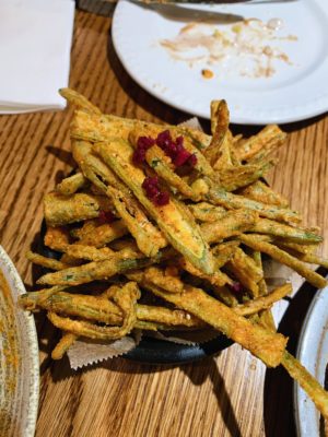 Porzhi okra fries served on black plate